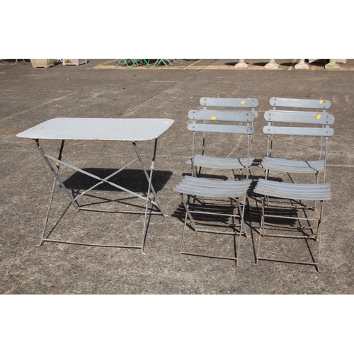 474 - French garden setting comprising of iron table with matching four folding slat chairs, table approx ... 