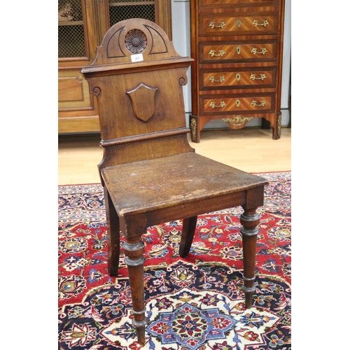 363 - Antique English hall chair with shield back, standing on turned front legs