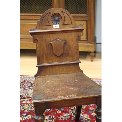 363 - Antique English hall chair with shield back, standing on turned front legs