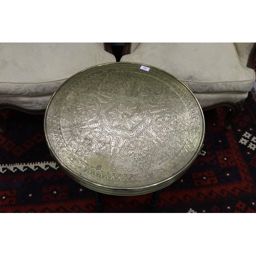 352 - Middle Eastern brass tray top circular coffee table, on fold out base, approx 53cm H x 60cm Dia