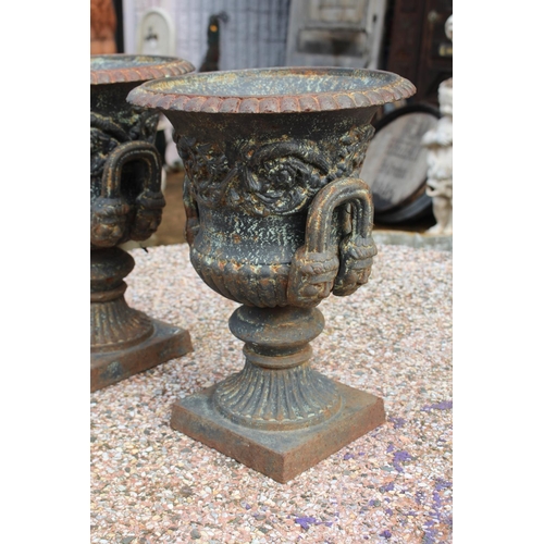 295 - Pair of antique French cast iron twin handled garden urns, nicely decorated and with male faces to t... 