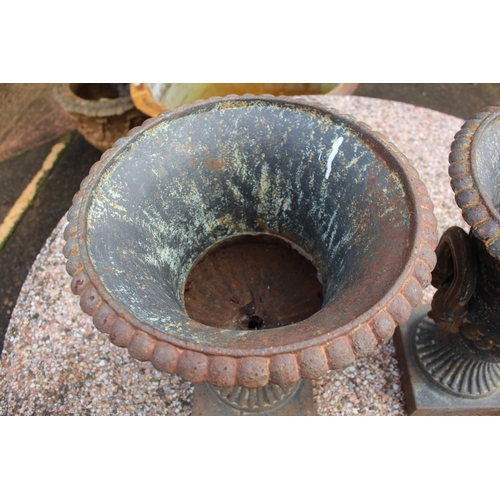 295 - Pair of antique French cast iron twin handled garden urns, nicely decorated and with male faces to t... 