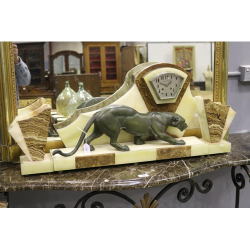 177 - French Art Deco figural mantle clock and garnitures, mounted with a spelter panther, marble and onyx... 
