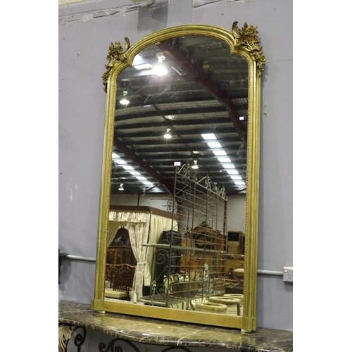 251 - Fine and large antique French gilt mantle mirror with shaped top & decoration, approx 178cm x 108cm