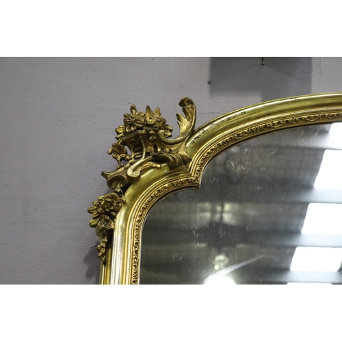 251 - Fine and large antique French gilt mantle mirror with shaped top & decoration, approx 178cm x 108cm