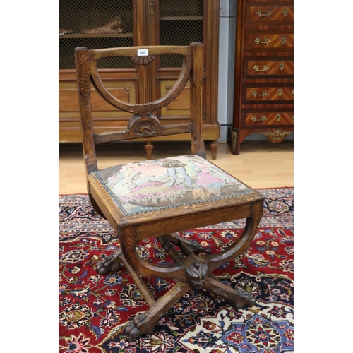 370 - Antique French X frame carved oak hall chair with needlework seat, central central mask head, and li... 