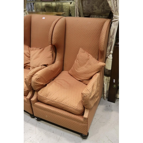 380 - Pair of wingback armchairs on castors with three cushions (2)