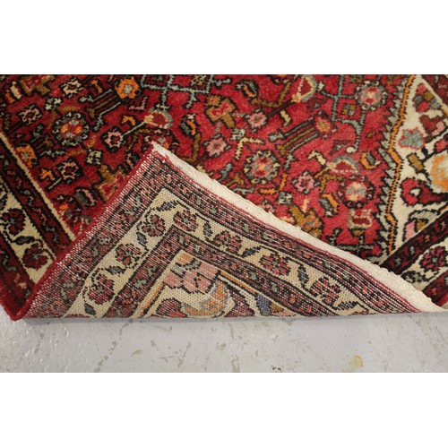 494 - North west Persian handmade wool red ground carpet, approx 83cm x 294cm