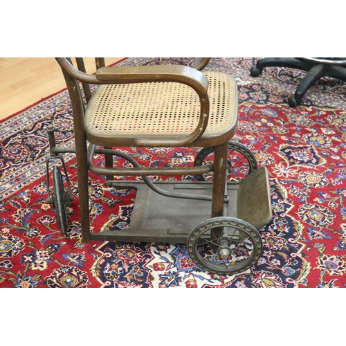 358 - Antique invalids armchair, on three wheels, bentwood with cane seat