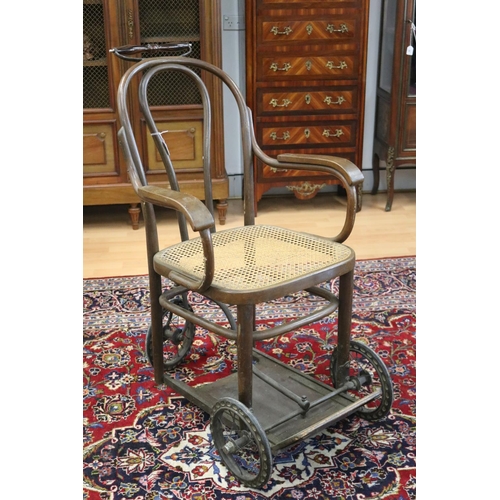 358 - Antique invalids armchair, on three wheels, bentwood with cane seat