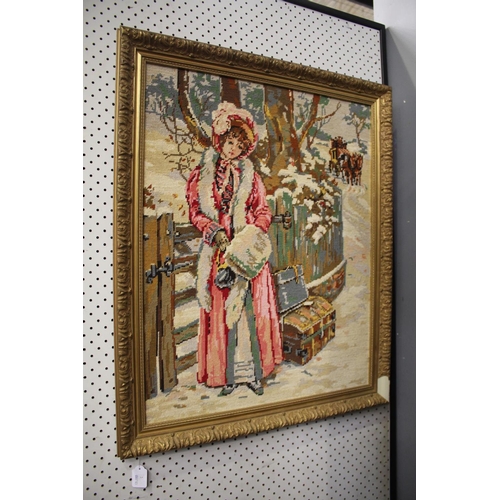 521 - Framed needlework of a female in the snow, approx 76cm x 63cm
