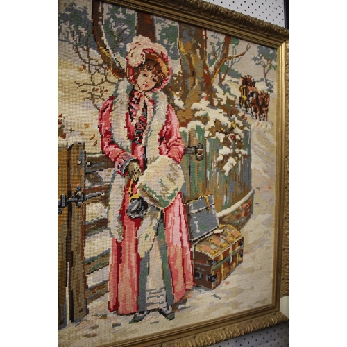 521 - Framed needlework of a female in the snow, approx 76cm x 63cm