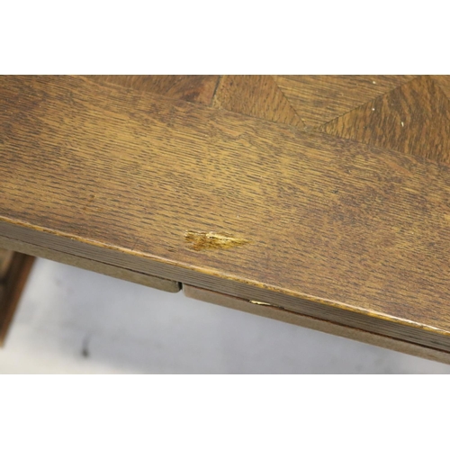 186 - French parquetry topped drawer leaf dining table, with large carved bulbous supports with scroll out... 