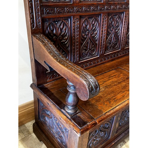 1144 - Antique English oak settle hall bench, well carved back, lift up seat compartment. Label for retaile... 