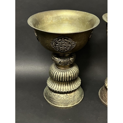 1009 - Pair of large Sino Tibetan metal pedestal fat offering bowls applied pierced decoration, approx 34cm... 