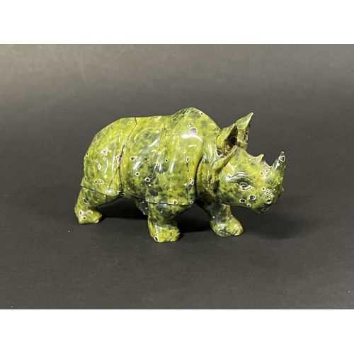1017 - Carved mottled Green stone rhino, approx 8cm H x 14cm L