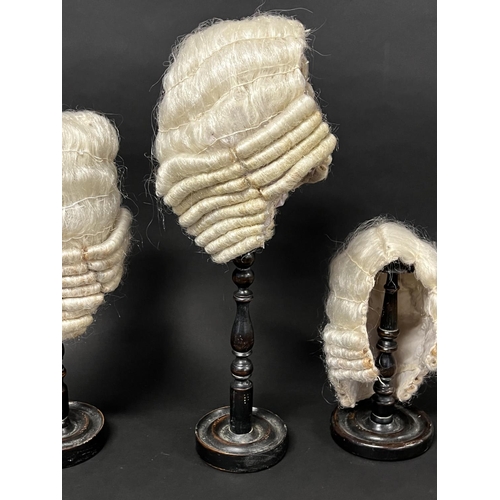 1102 - Three turned wood hat or wig stands with three wigs, approx 45.5cm H and shorter (3)