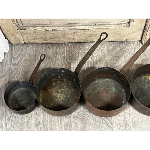 1105 - Six antique French copper and iron handled saucepans, approx 50cm L and shorter (6)