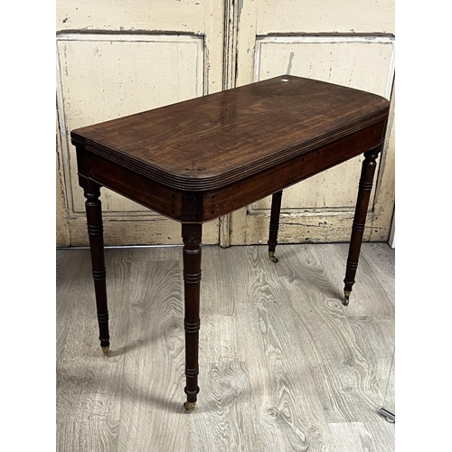 1115 - Antique Regency fold over card table canted front, with ebony stringing and inlaid buttons, standing... 