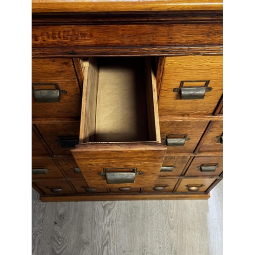 1133 - Good antique English oak 20 drawer filing cabinet, with brass cup pulls, engraved Shannon, approx 11... 