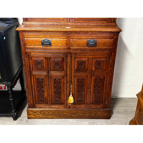 1135 - Petit Antique English oak two height bookcase, carved in high relief to the two door base, approx 22... 