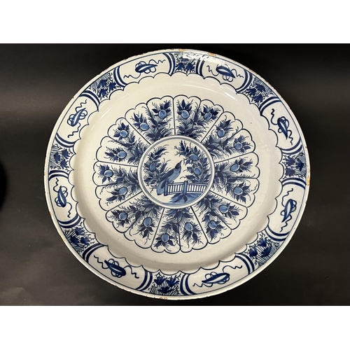 1346 - Large Antique Dutch Delft charger, decorated with a bird on a fence and peacock feather surround, ap... 