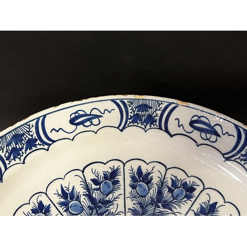1346 - Large Antique Dutch Delft charger, decorated with a bird on a fence and peacock feather surround, ap... 