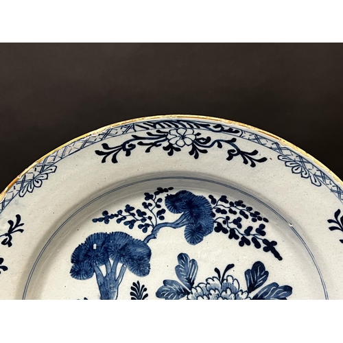 1351 - Antique 18th century Delft blue and white charger, decorated with trellis fence and pine tree, circa... 