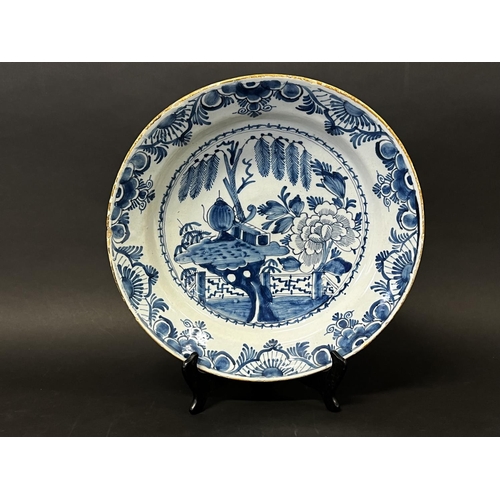 1352 - Antique 18th century Dutch Delft charger, decorated in blue with oriental garden, with trellis fence... 