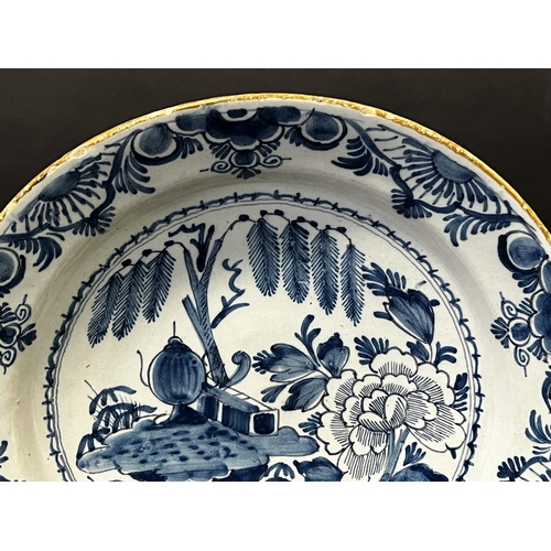 1352 - Antique 18th century Dutch Delft charger, decorated in blue with oriental garden, with trellis fence... 
