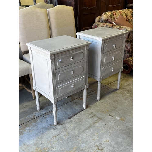 1357 - Pair of French Louis XVI revival three drawer bedside cabinets, distressed painted finish. Drop pend... 