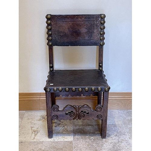 1384 - Antique early 17th century chair, with large brass studded embossed leather back and seat, carved pi... 
