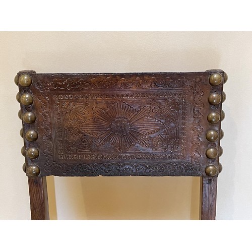 1384 - Antique early 17th century chair, with large brass studded embossed leather back and seat, carved pi... 