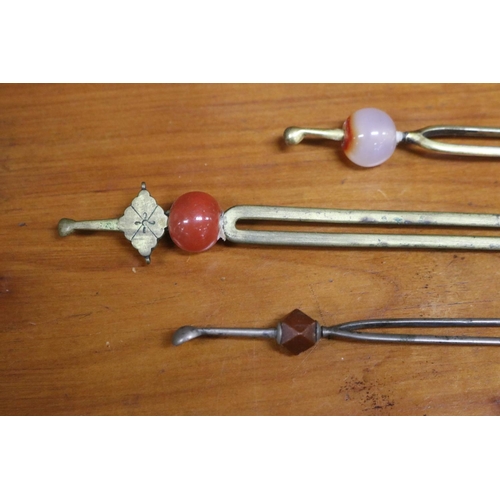 20 - Three South East Asian / Thai hair pins, two mounted with agate beads, approx 21cm L and shorter (3)