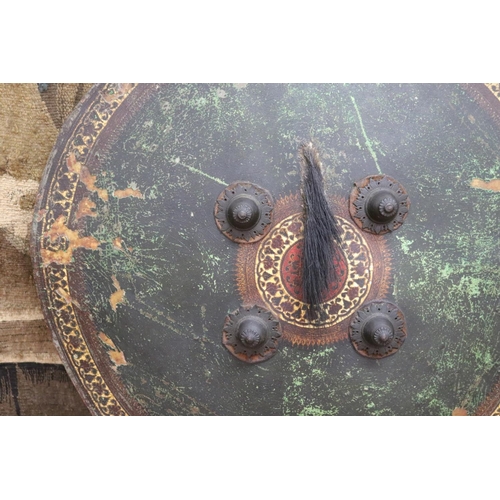 5 - Indian Dahl of circular form in painted leather, complete with its hand grips and padded buffer, a n... 