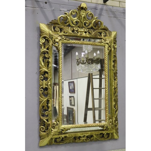 119 - Large antique 19th century French giltwood pierced surround cushion mirror, with central elaborate c... 