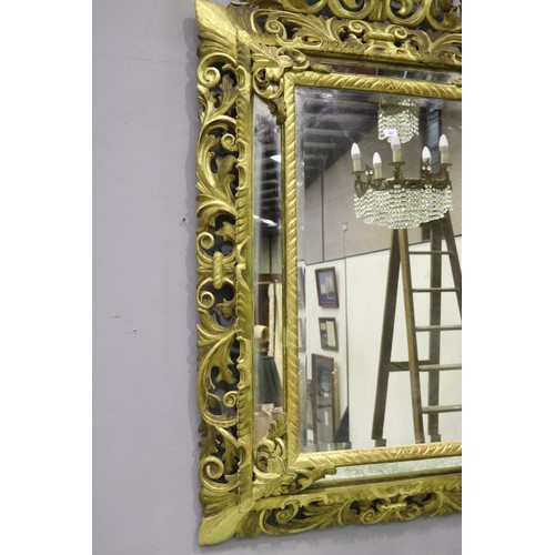 119 - Large antique 19th century French giltwood pierced surround cushion mirror, with central elaborate c... 