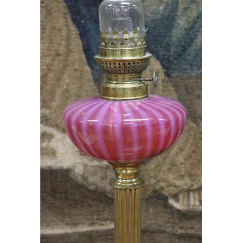 155 - Antique oil lamp, ruby and vaseline reservoir with brass column and base, approx 68cm H