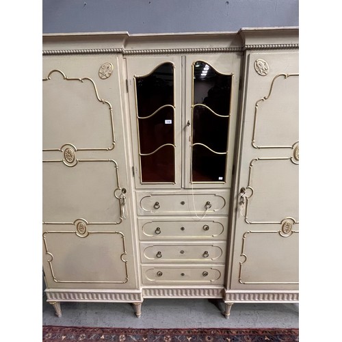 162 - Antique early 20th century Hollywood regency cream painted inverted break front two door armoire, wi... 