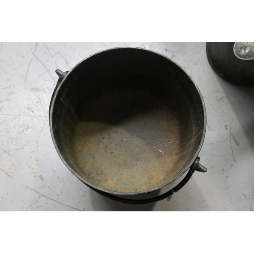 46 - Cast iron pot standing on legs, swing handled and with lid, approx 44cm H ex handle x 41cm Dia