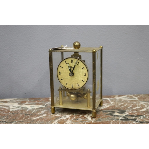 112 - Small glass clock with brass frame, back glass missing, no key, unknown working condition, approx 17... 