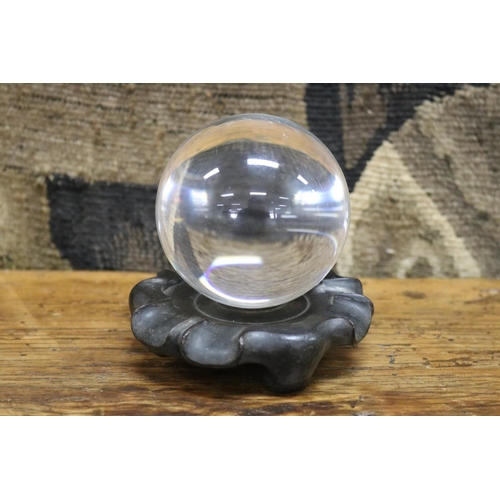 26 - Oriental crystal ball on carved wood stand, ball approx 8cm Dia