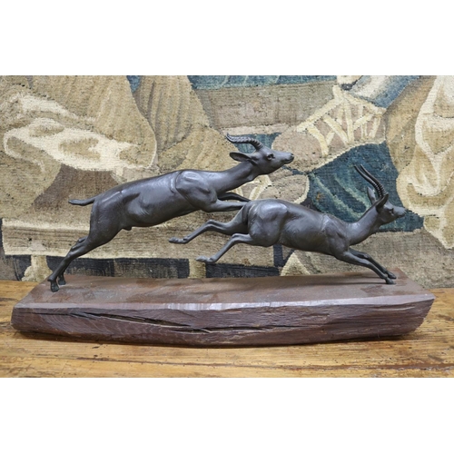 55 - French sculpture of two antelope running, mounted to a wooden plinth base, marked FRANCE to figure, ... 