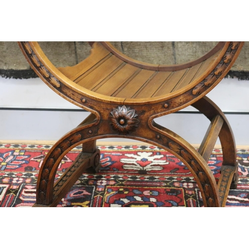 77 - Italian walnut savonarola / X frame armchair, carved lion mask decoration