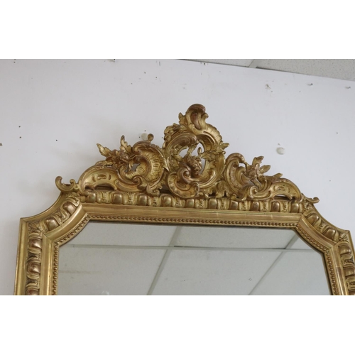 154 - Antique French gilt salon mirror, shaped edges, C scroll decoration to top, approx 142cm H x 89cm W