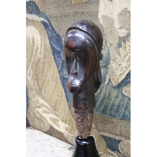 184 - An African Fang funerary head, mounted on an ebonised base, approx 57cm H