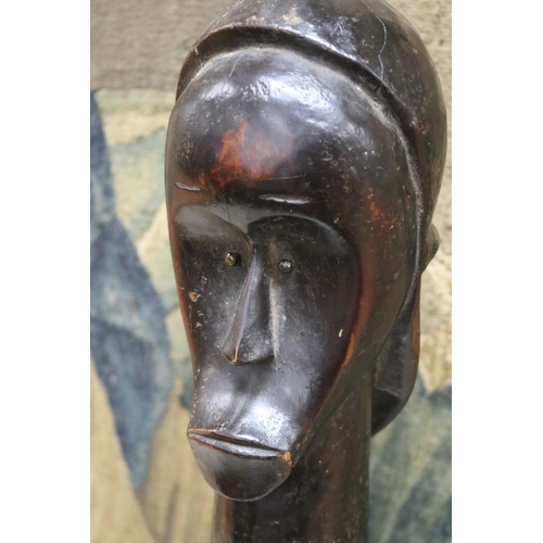 184 - An African Fang funerary head, mounted on an ebonised base, approx 57cm H