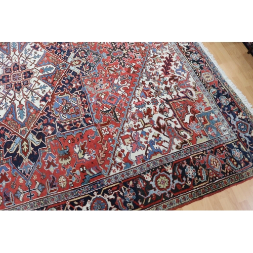 196 - Large Persian Heriz hand knotted carpet, approx 367cm x 270cm