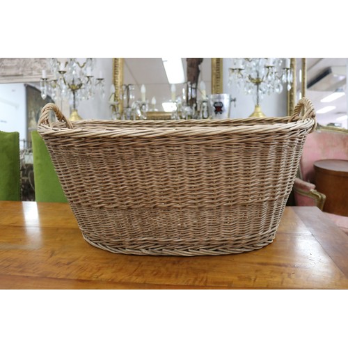 203 - Vintage French twin handled hand woven cane laundry basket of oval form, approx 39cm H x 75cm W x 51... 