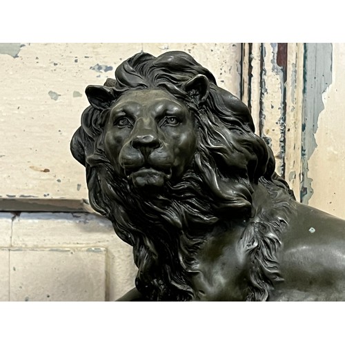 1037 - Bronze of a recumbent lion, after Barye, on a black marble base, approx 20cm H x 32cm W x 15cm D